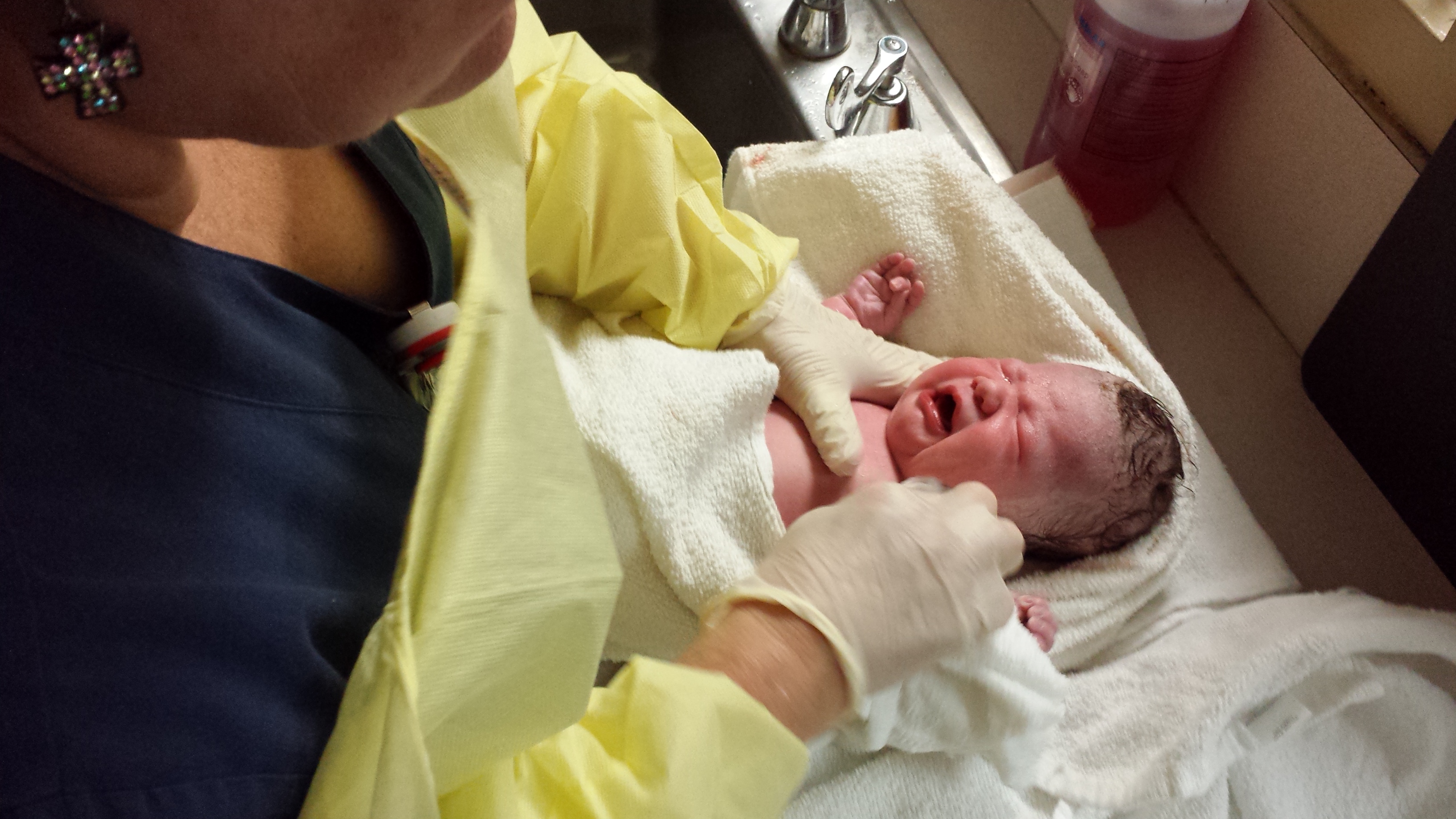 Chloe in the nursery crib under a heat lamp for her first measurements