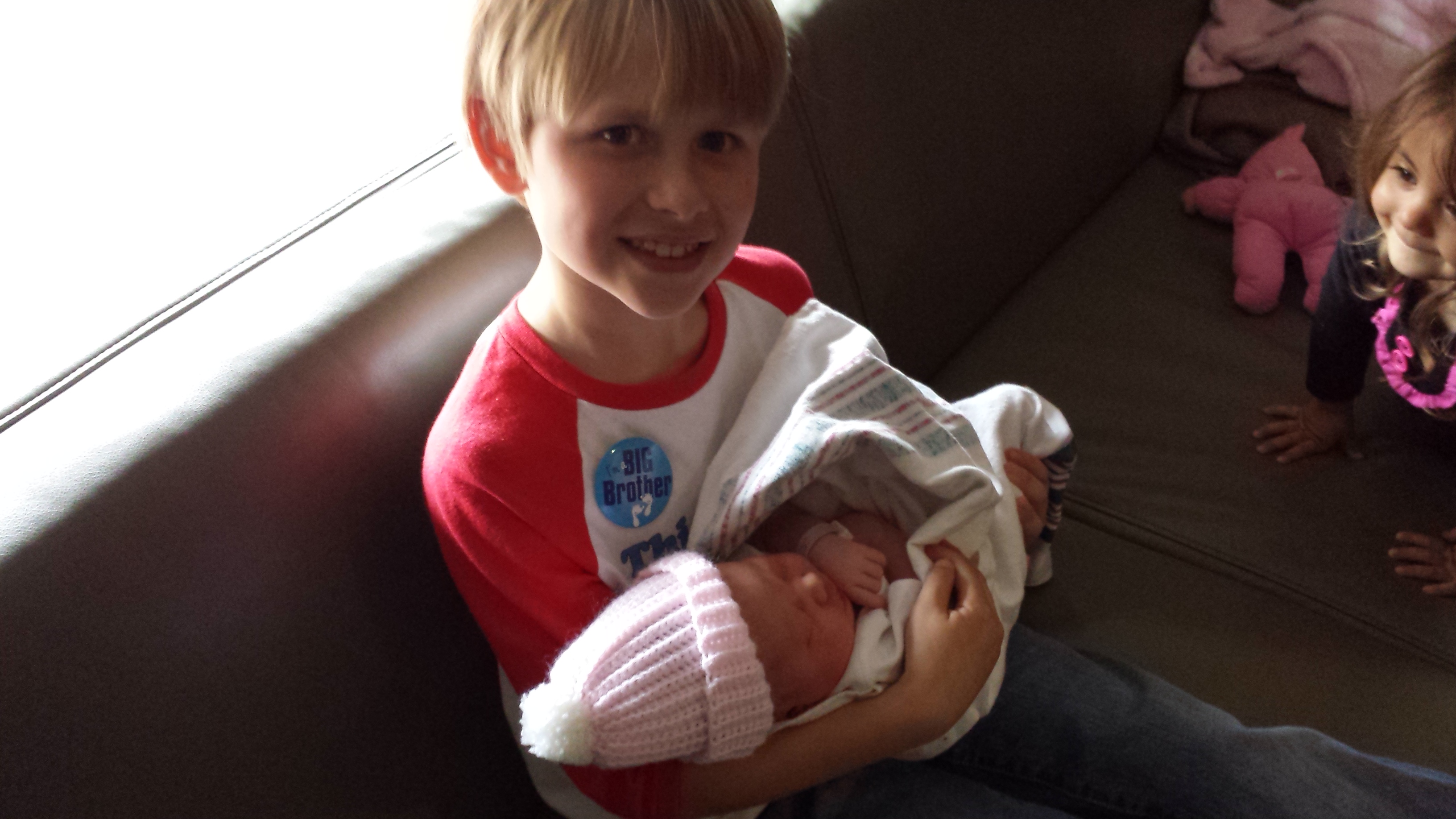 Chase holding his baby sister Chloe for the first time