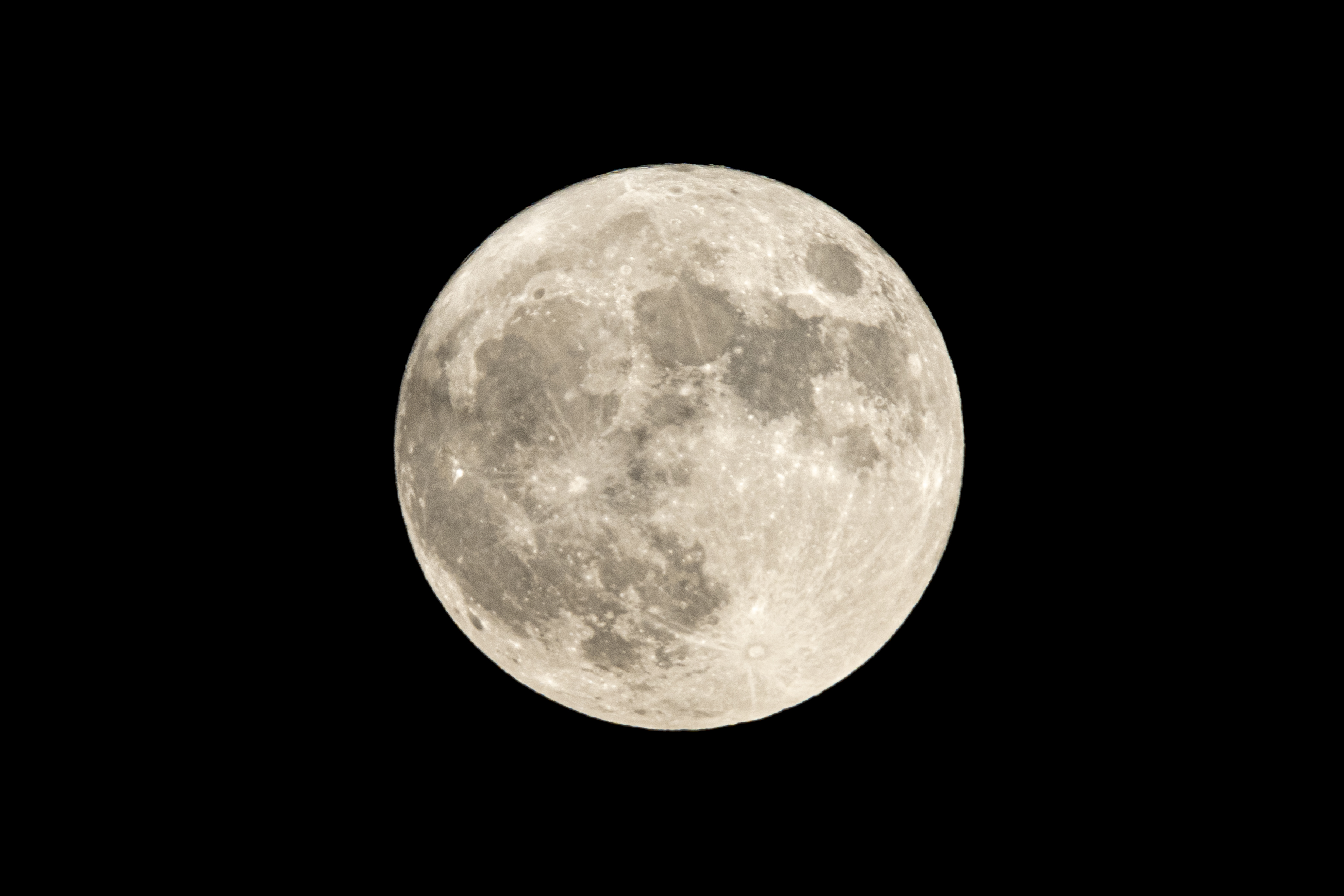 a full moon is seen in the sky with a black sky in the back ground and a plane in the foreground