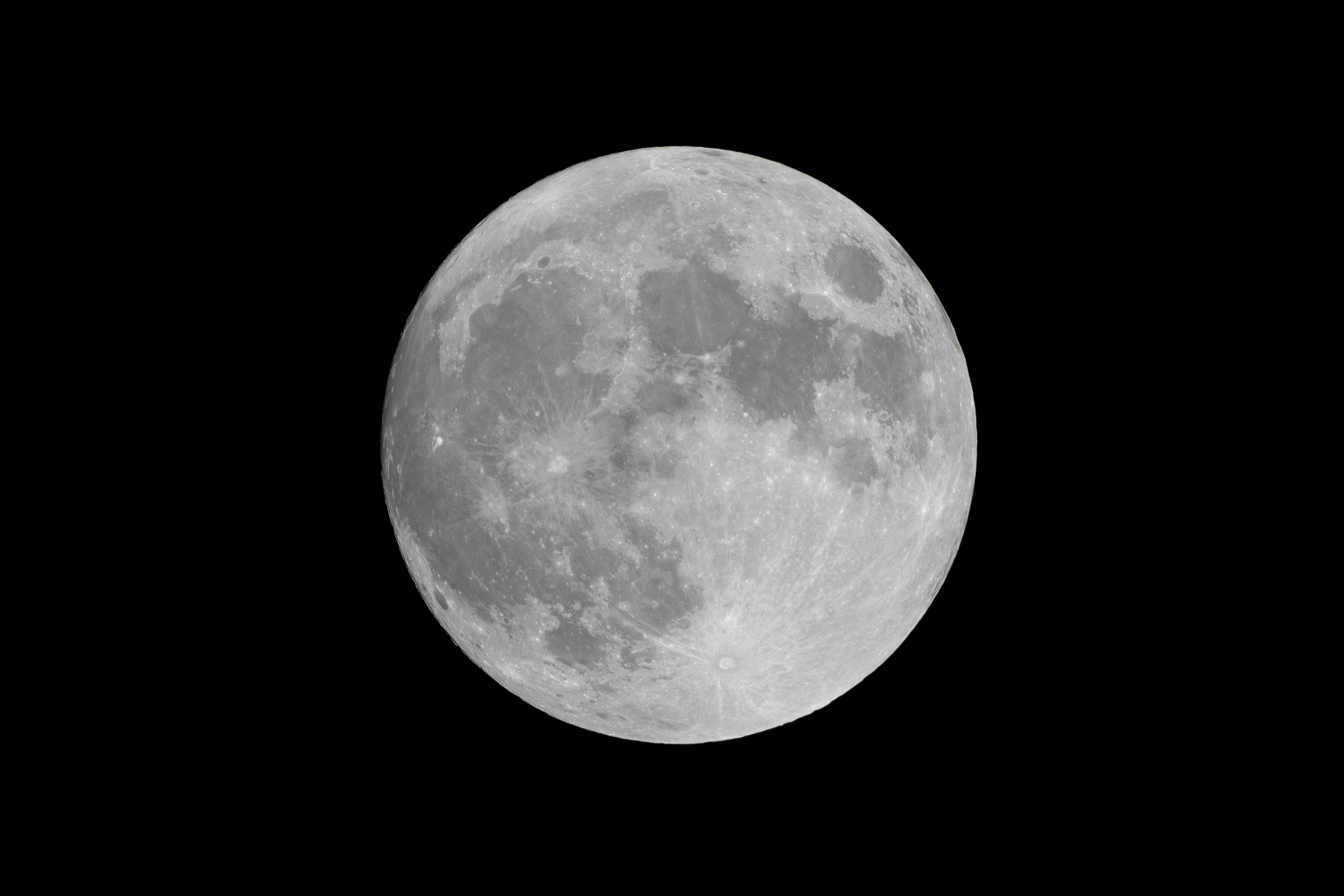 a full moon in the dark sky with no clouds on it