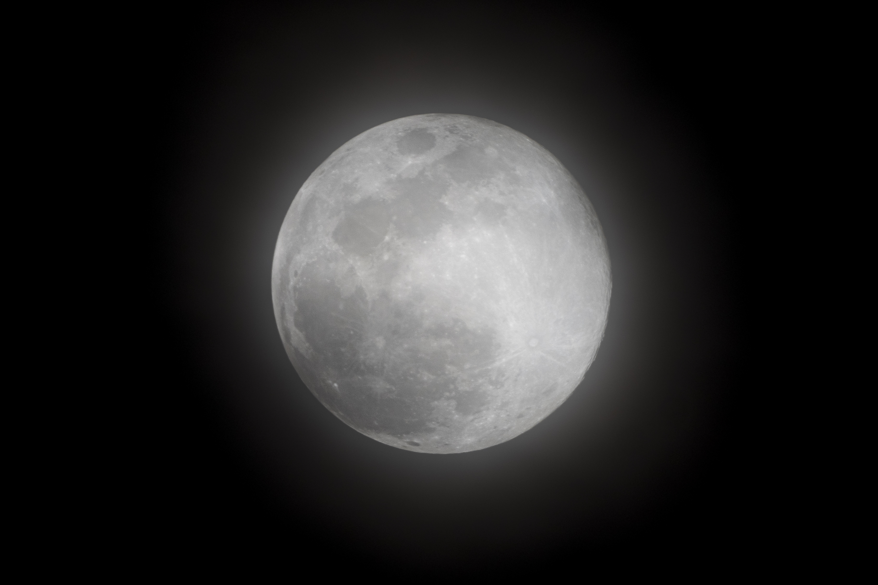 a full moon in the dark sky with no clouds on it