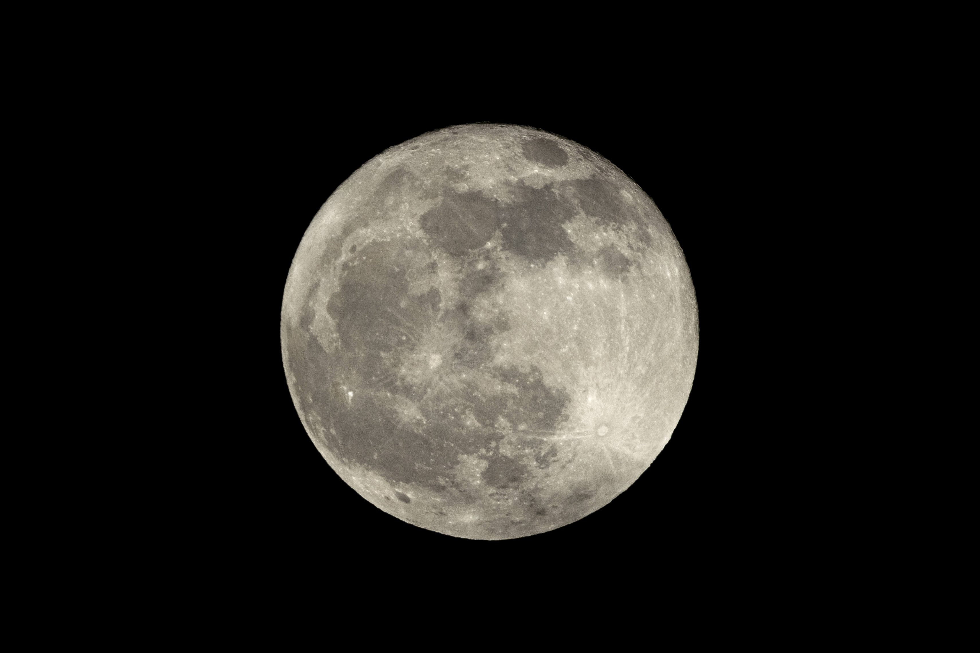 a full moon is seen in the sky with a black sky in the back ground and a plane in the foreground