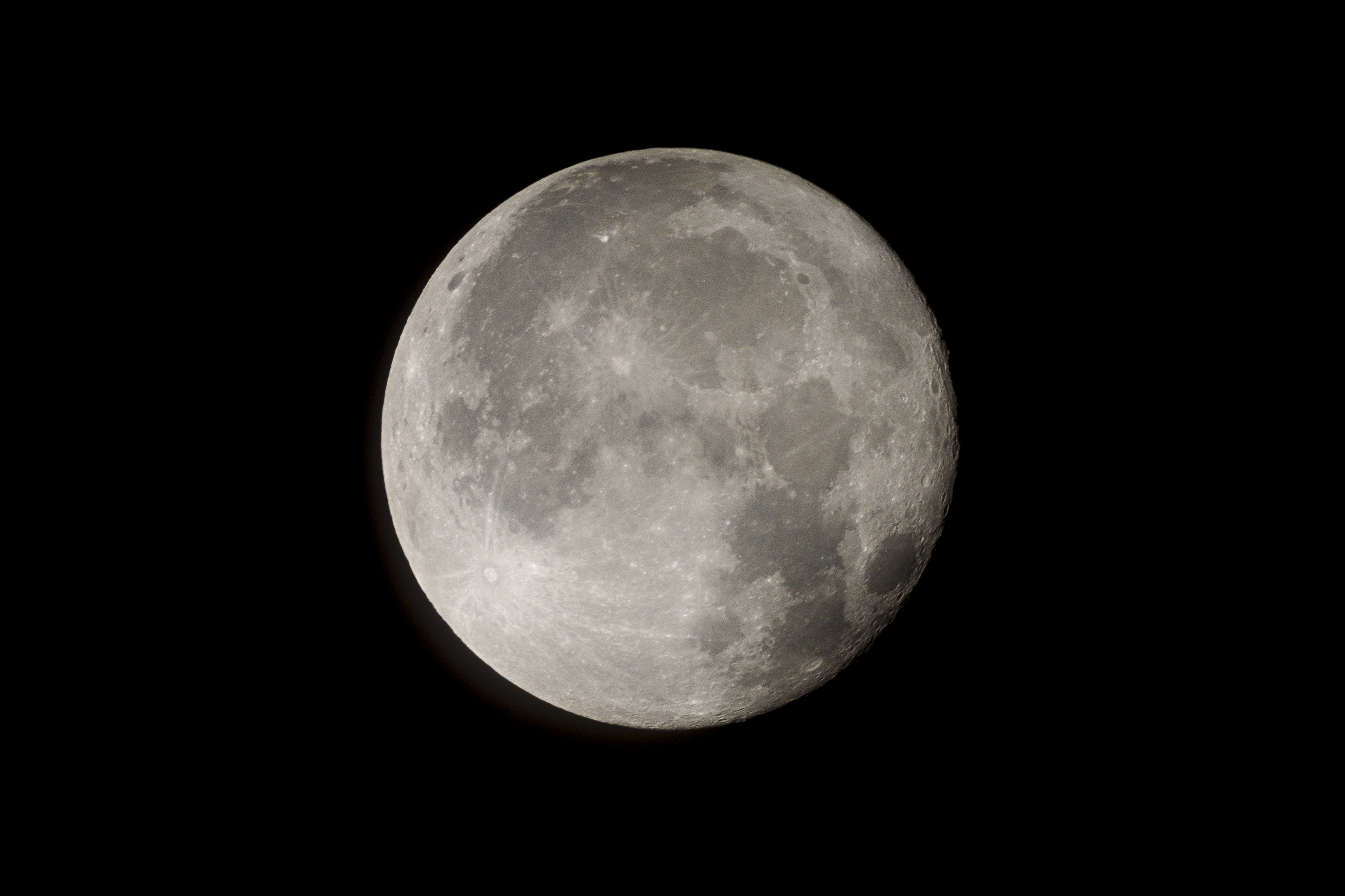a full moon in the dark sky with a plane in the foreground and a plane in the foreground