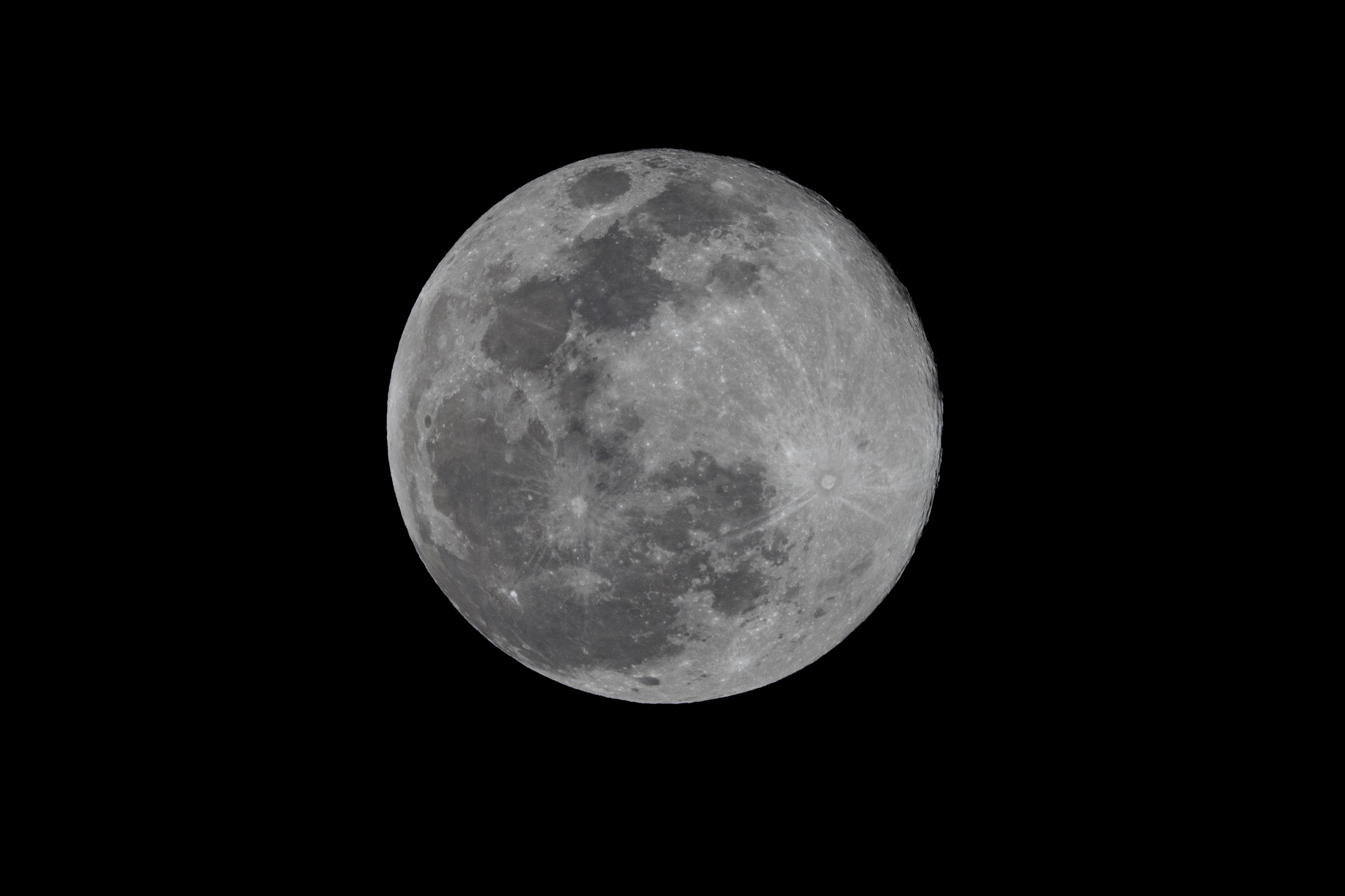 a full moon in the dark sky with a plane in the foreground and a plane in the foreground